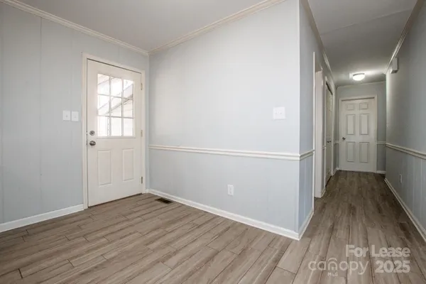 a view of an empty room with wooden floor