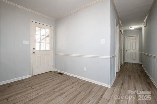 a view of an empty room with wooden floor
