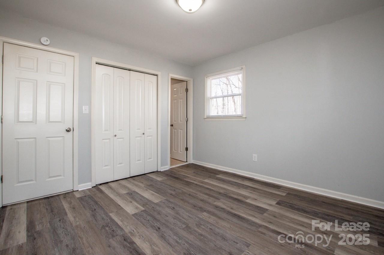 1159 Camp Creek Road Iron Station, NC 28080 - Photo 22 of 48 a view of an empty room with wooden floor