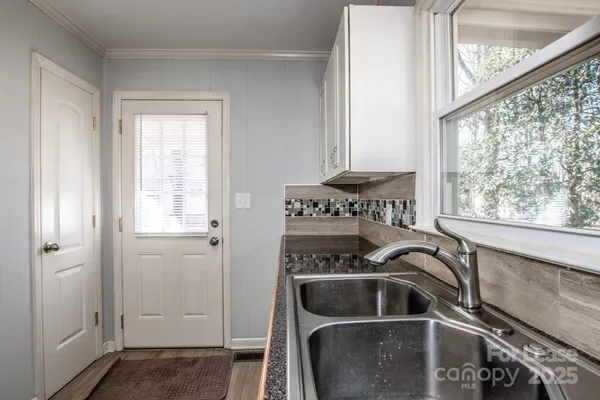 a kitchen with stainless steel appliances a stove a microwave and a refrigerator