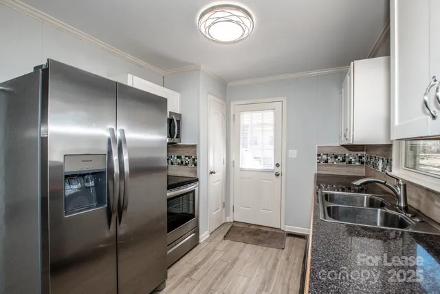 a kitchen that has a sink and a stove top oven