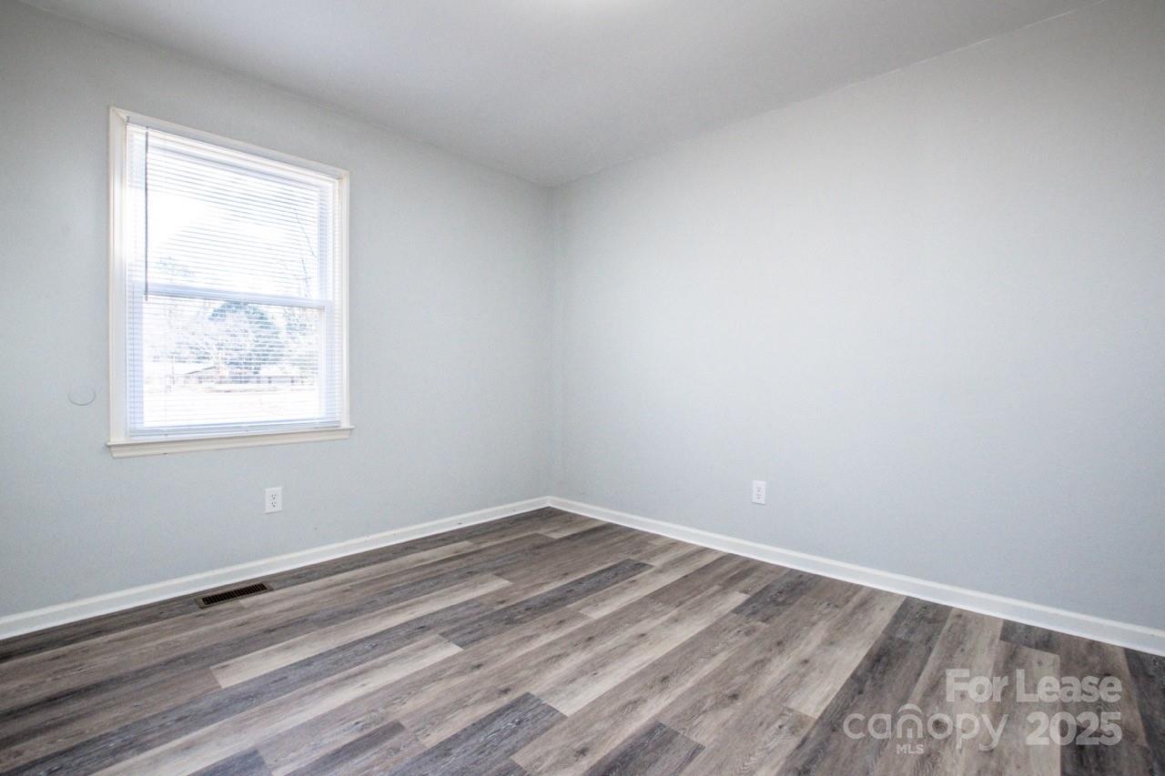 1159 Camp Creek Road Iron Station, NC 28080 - Photo 34 of 48 wooden floor in an empty room with a window