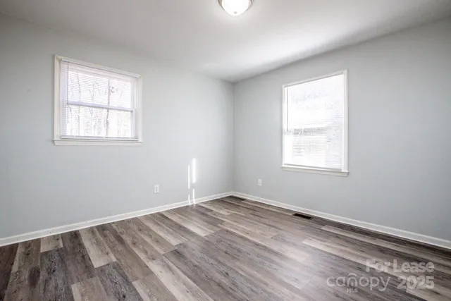 a bathroom with a granite countertop toilet sink and mirror