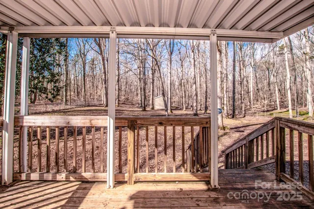 a view of a porch with wooden floor and fence