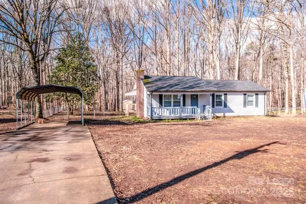 a front view of a house with yard and green space