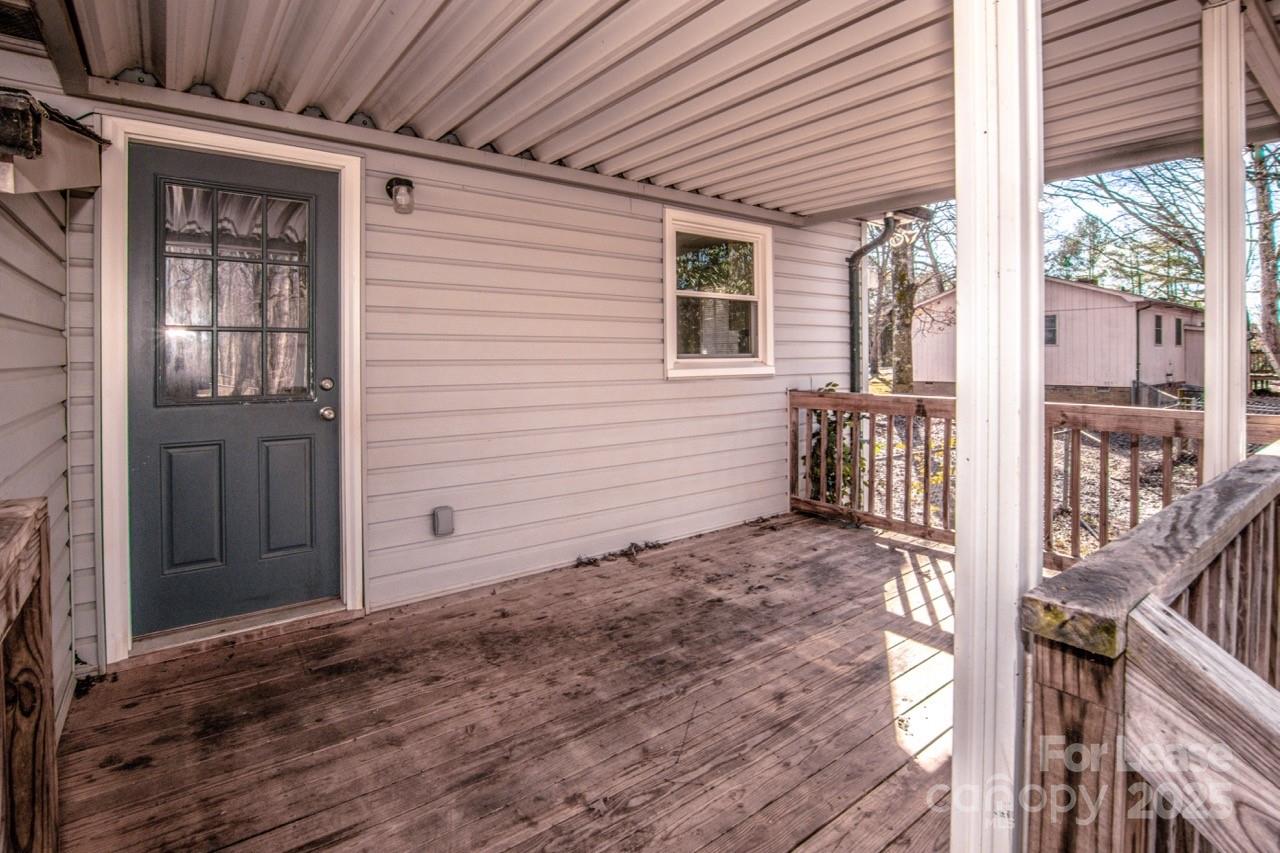 1159 Camp Creek Road Iron Station, NC 28080 - Photo 41 of 48 a view of a porch with wooden floor and fence