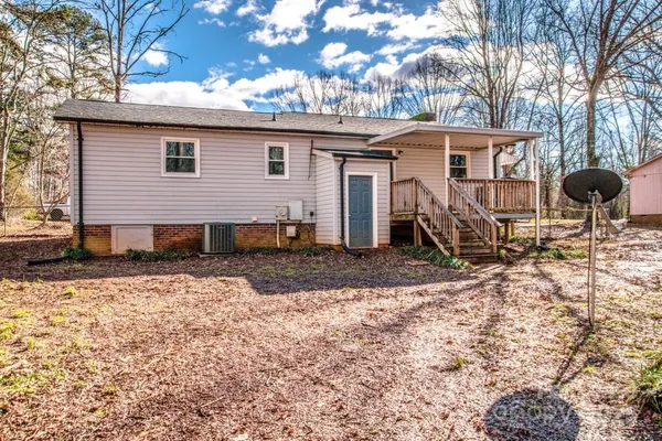 a view of a house with a yard covered with snow