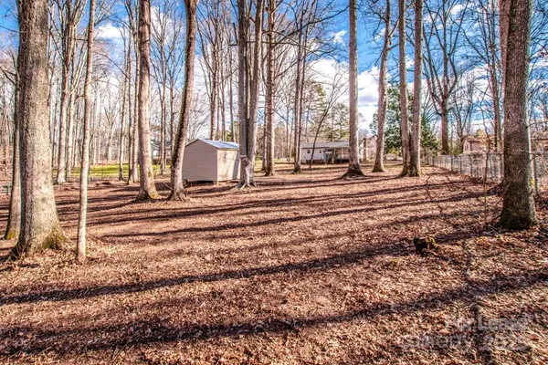 a view of a house with a trees in the background