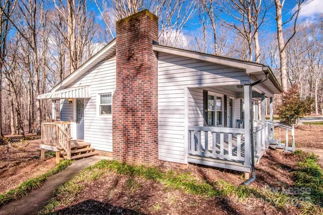 a view of a house with a wooden fence