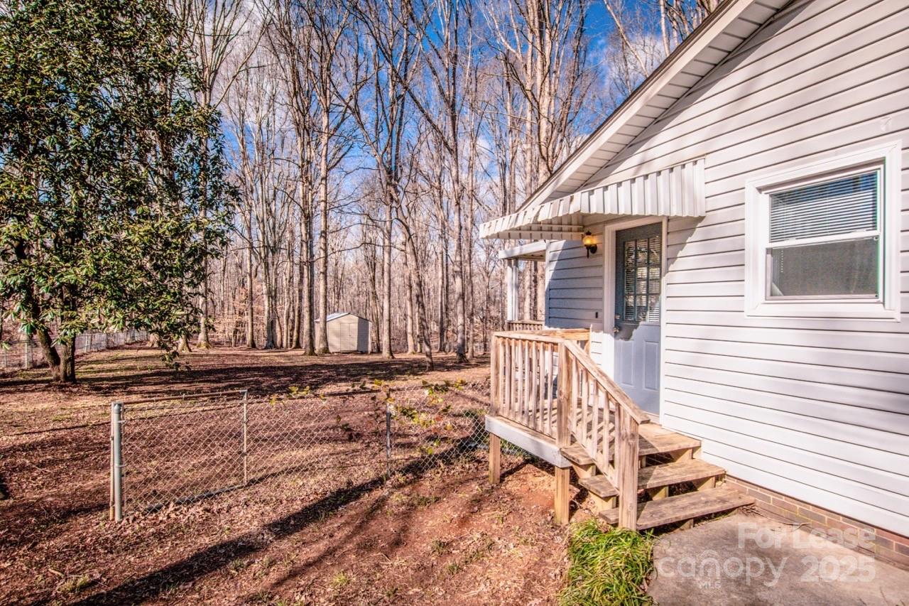 1159 Camp Creek Road Iron Station, NC 28080 - Photo 8 of 48 a view of a house with a wooden fence