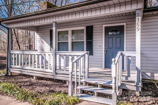 a view of empty room with wooden floor and fireplace