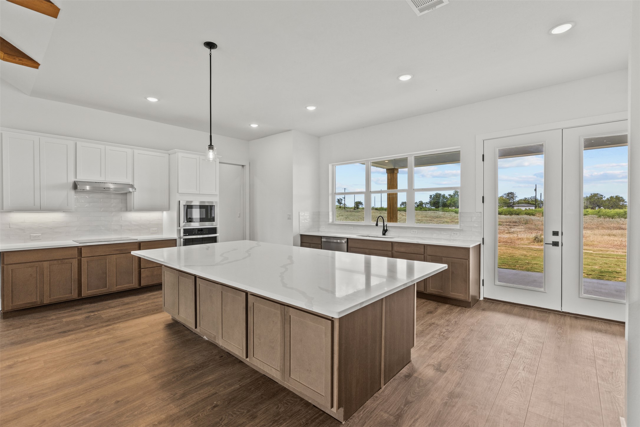1420 Barth Road Dale, TX 78616 - Photo 8 of 37 A well-appointed kitchen features a grand island, abundant cabinetry, and sweeping views of the surrounding landscape.