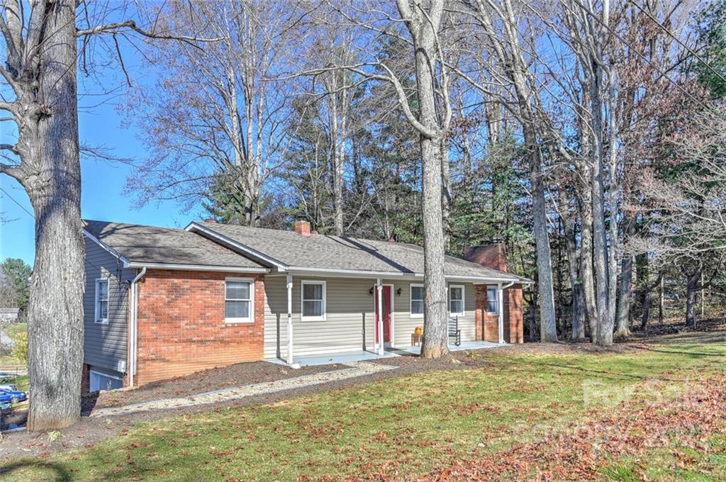 685 Kims Cove Road Canton, NC 28716 - Photo 1 of 43 a front view of a house with a garden