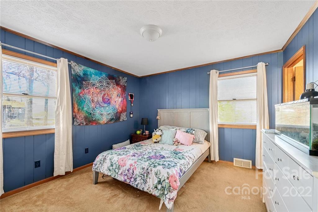685 Kims Cove Road Canton, NC 28716 - Photo 17 of 43 a bedroom with a bed and a flat screen tv
