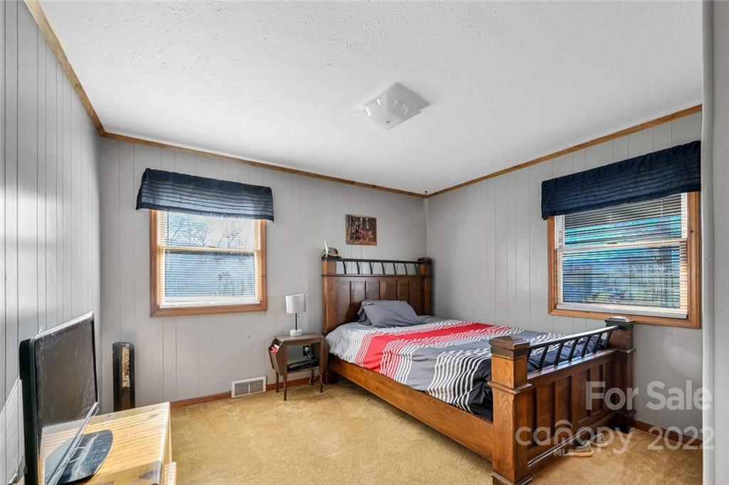 685 Kims Cove Road Canton, NC 28716 - Photo 19 of 43 a bedroom with a bed and a tv on the dresser