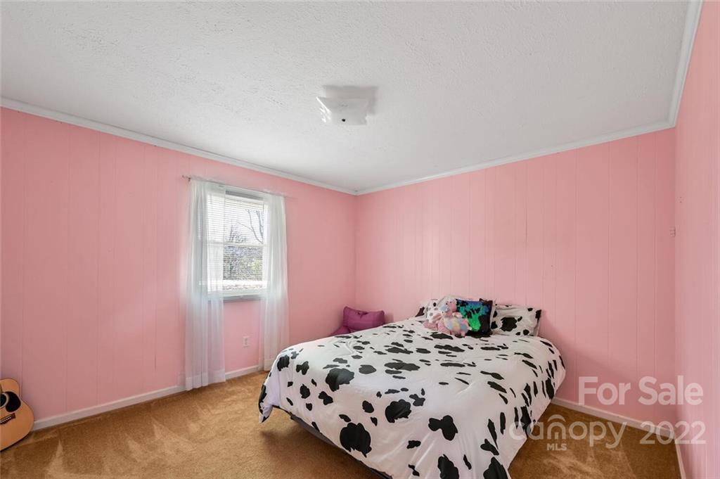 685 Kims Cove Road Canton, NC 28716 - Photo 20 of 43 a bedroom with a bed and a window