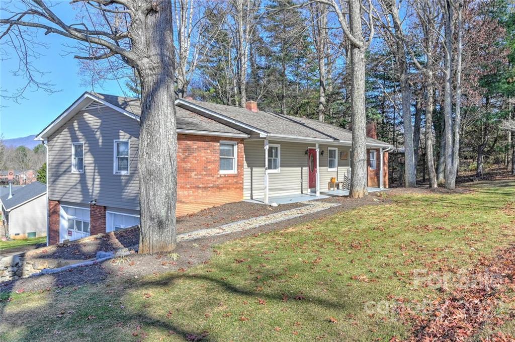 685 Kims Cove Road Canton, NC 28716 - Photo 2 of 43 a view of a yard in front of a house with large tree