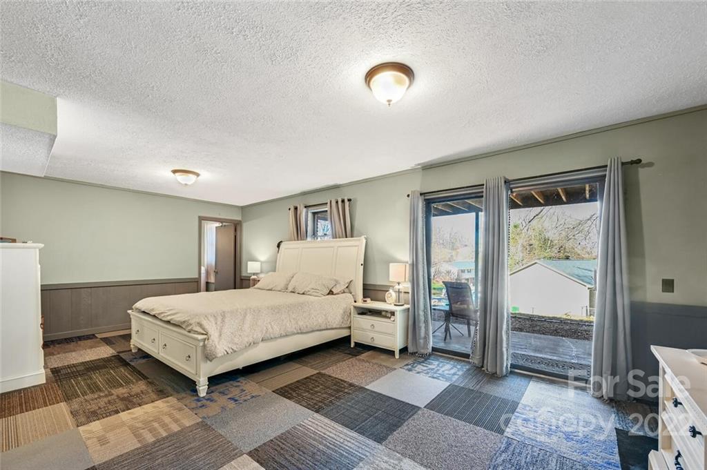 685 Kims Cove Road Canton, NC 28716 - Photo 23 of 43 a bedroom with a bed and a mirror