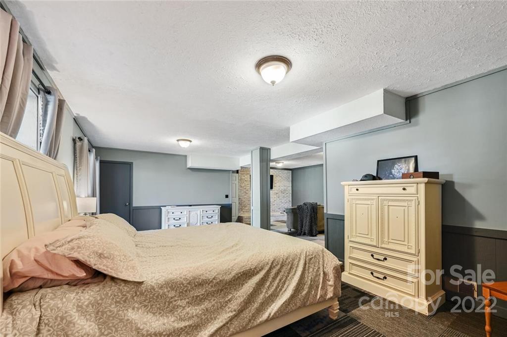 685 Kims Cove Road Canton, NC 28716 - Photo 24 of 43 a bedroom with a bed and a refrigerator