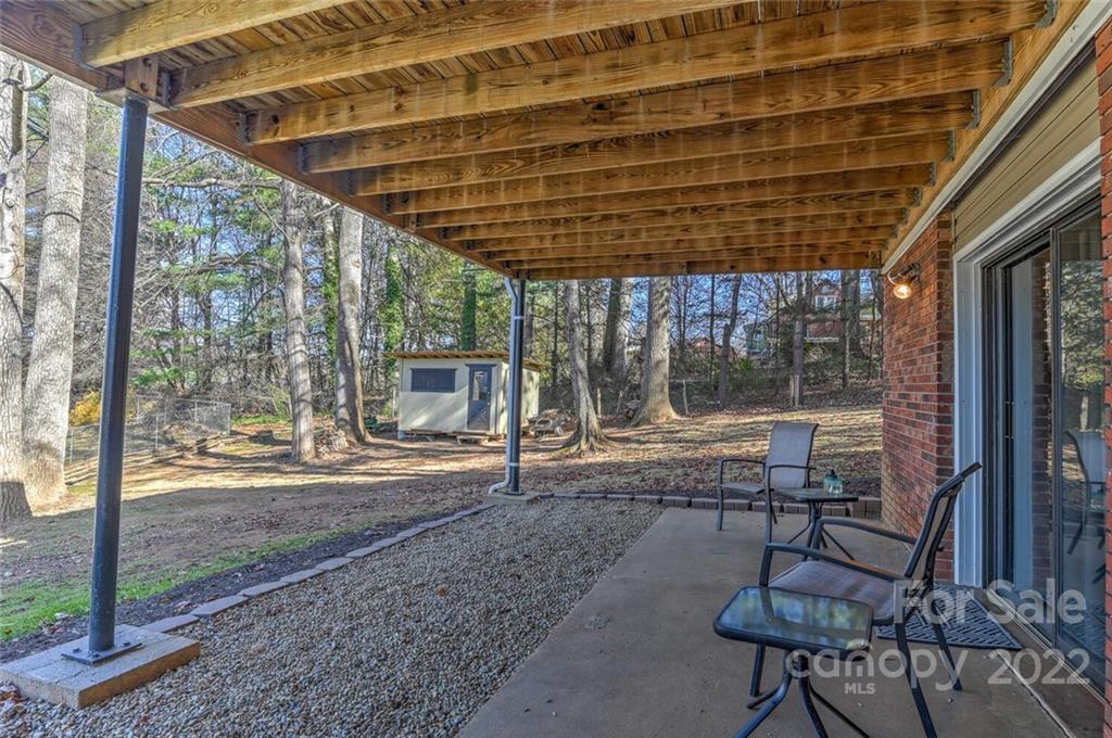 685 Kims Cove Road Canton, NC 28716 - Photo 31 of 43 a view of a patio with a table chairs and wooden floor
