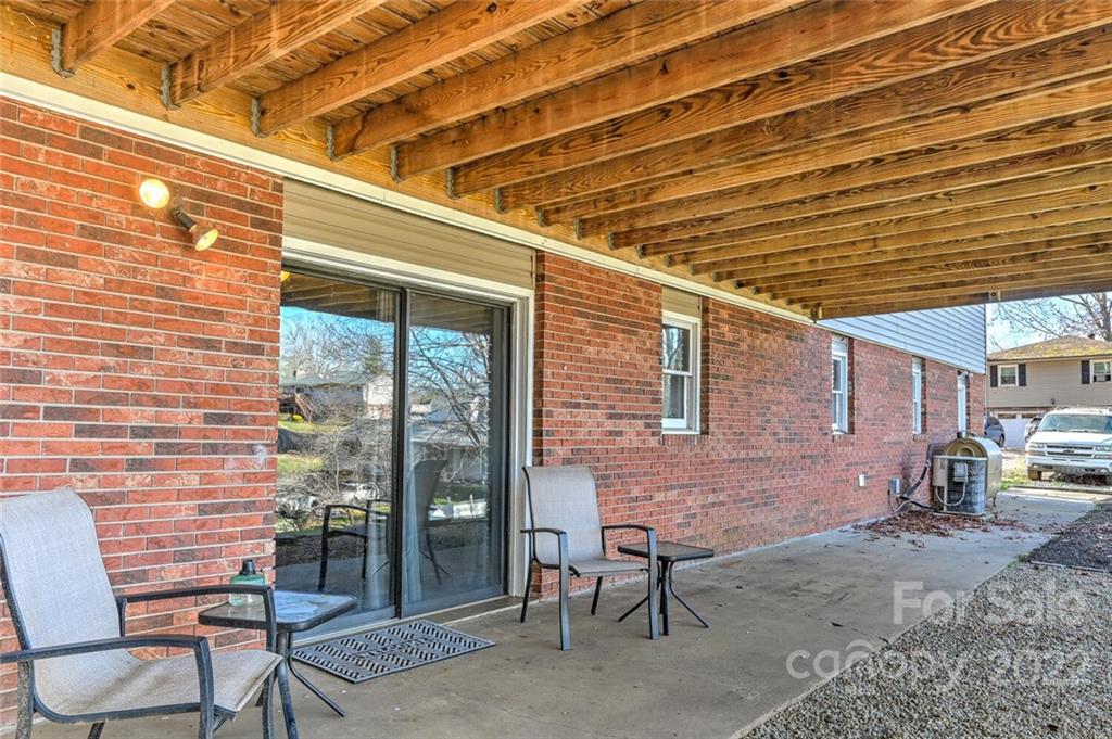 685 Kims Cove Road Canton, NC 28716 - Photo 32 of 43 a patio with table and chairs and potted plants