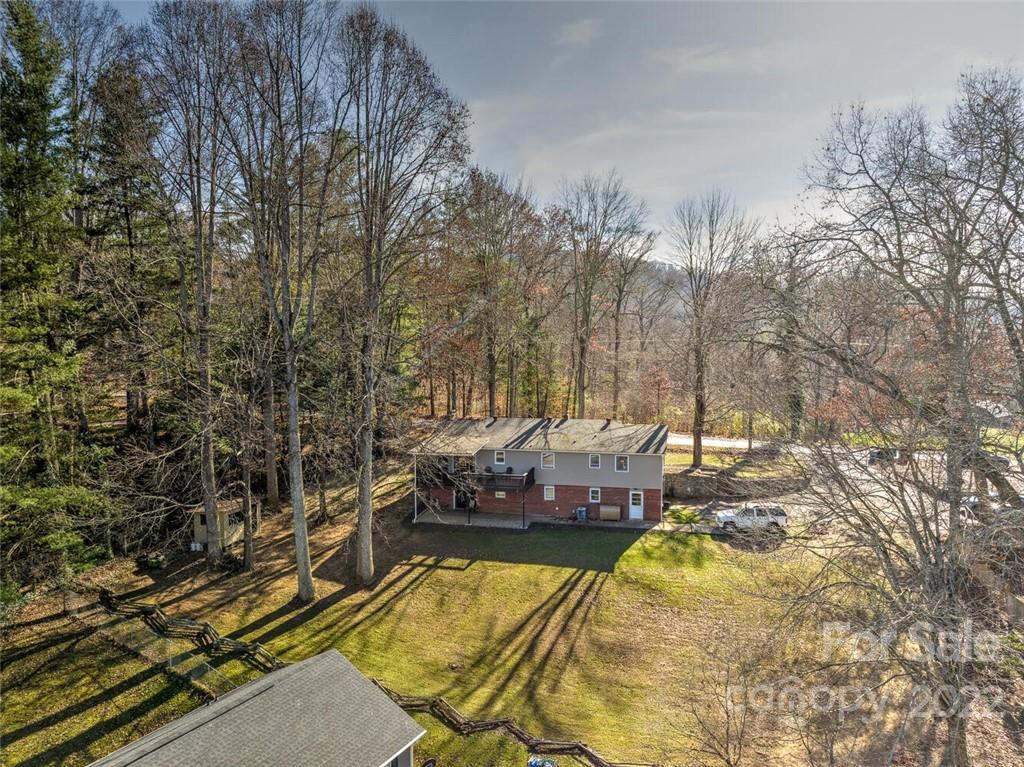 685 Kims Cove Road Canton, NC 28716 - Photo 43 of 43 a view of a swimming pool with a yard and trees