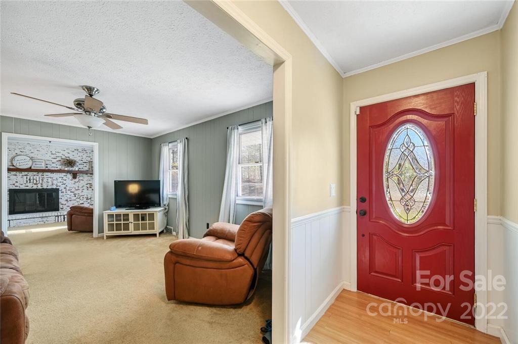 685 Kims Cove Road Canton, NC 28716 - Photo 5 of 43 a living room with furniture a fireplace and a flat screen tv