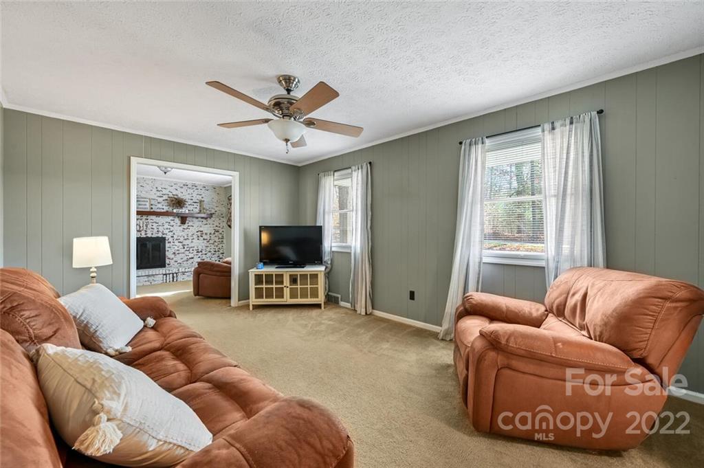 685 Kims Cove Road Canton, NC 28716 - Photo 6 of 43 a living room with furniture ceiling fan and a window