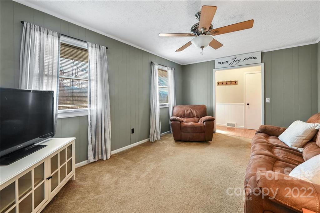 685 Kims Cove Road Canton, NC 28716 - Photo 7 of 43 a living room with furniture and a flat screen tv