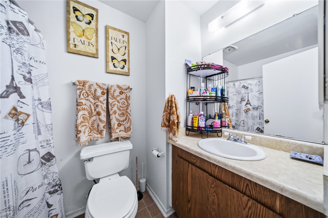 793 Baseline Road Bullhead City, AZ 86442 - Photo 28 of 49 Bathroom vanity featuring a laminate countertop with an integrated sink and a wood-finish cabinet