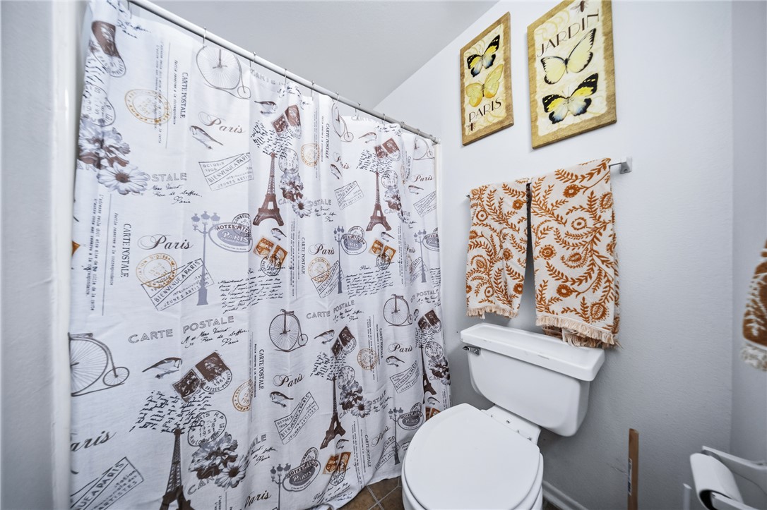 793 Baseline Road Bullhead City, AZ 86442 - Photo 29 of 49 Bathroom featuring a white toilet, tile flooring, and white painted walls