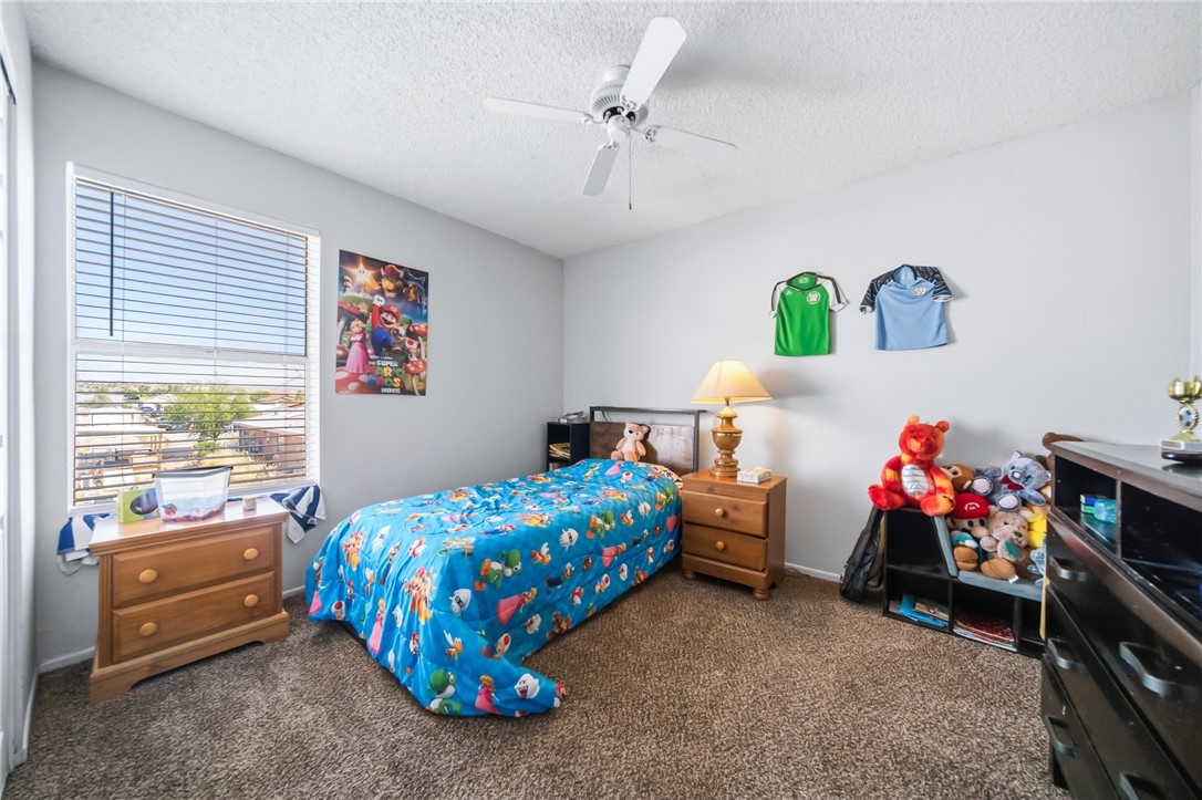 793 Baseline Road Bullhead City, AZ 86442 - Photo 30 of 49 Carpeted room with a ceiling fan light fixture