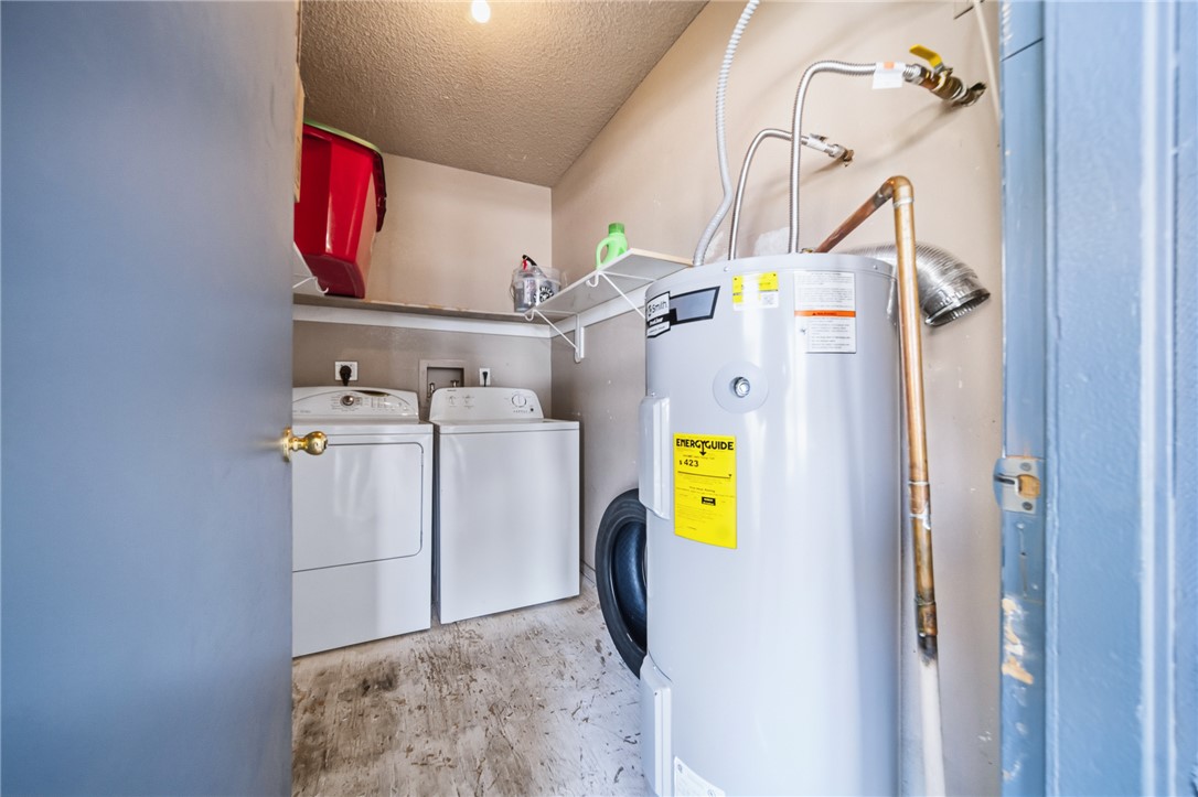 793 Baseline Road Bullhead City, AZ 86442 - Photo 32 of 49 Dedicated utility space featuring a water heater, washer, and dryer connections
