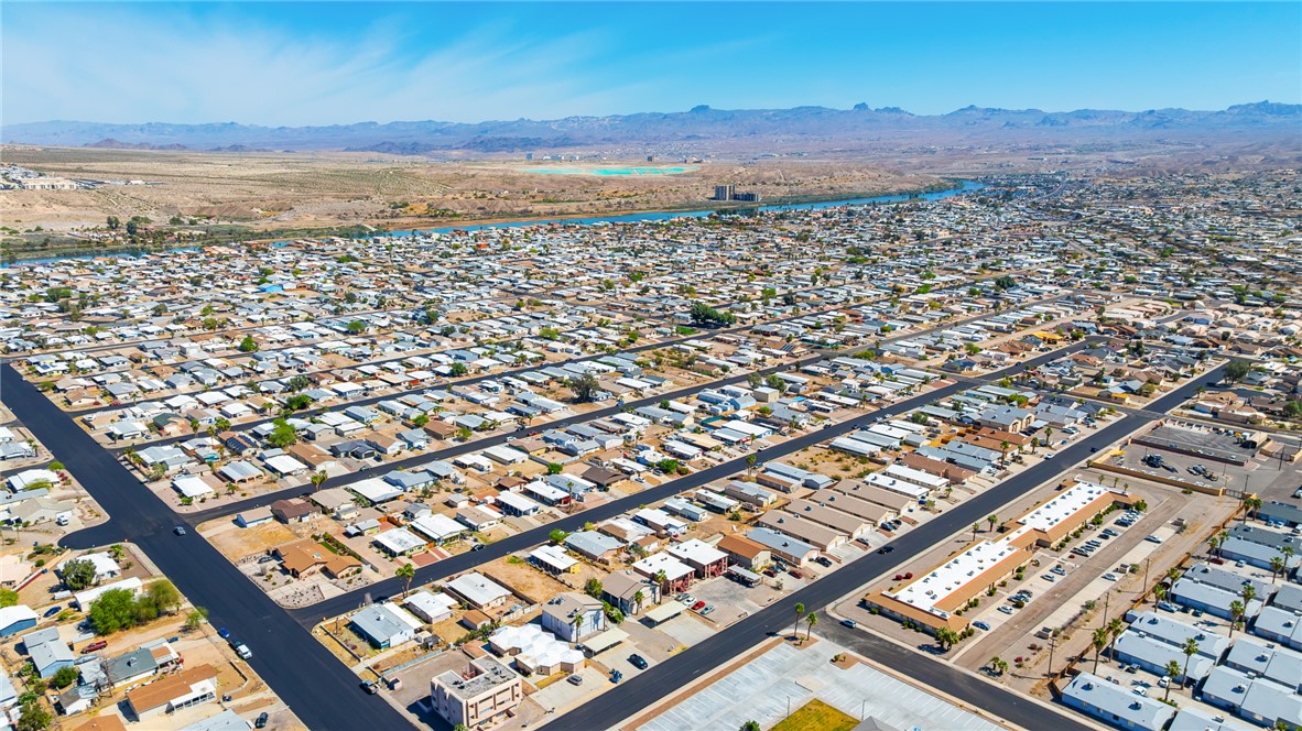 793 Baseline Road Bullhead City, AZ 86442 - Photo 36 of 49 Aerial perspective showcasing a residential community with a distant river and mountain range backdrop