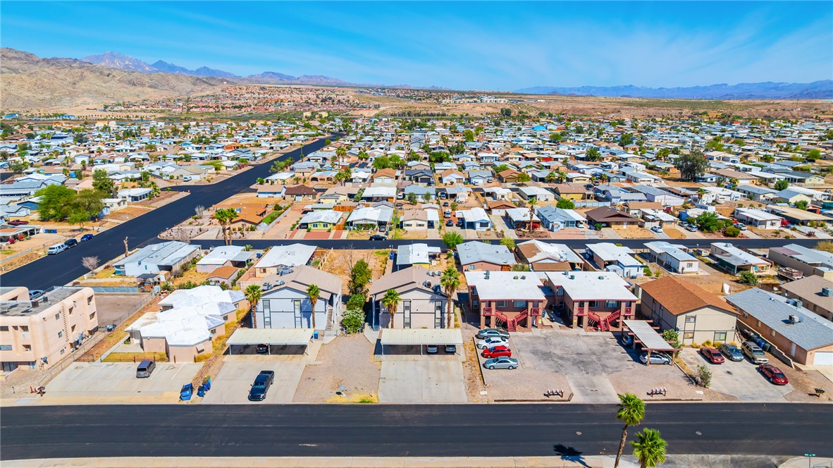 793 Baseline Road Bullhead City, AZ 86442 - Photo 38 of 49 Expansive neighborhood with diverse residential structures, extensive paved roadways, and a prominent mountainous backdrop
