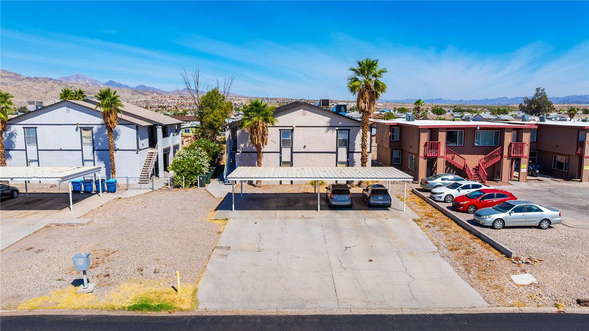 793 Baseline Road Bullhead City, AZ 86442 - Photo 39 of 49 Multi-unit property featuring two-story buildings with exterior staircases, carports, and open-air parking areas