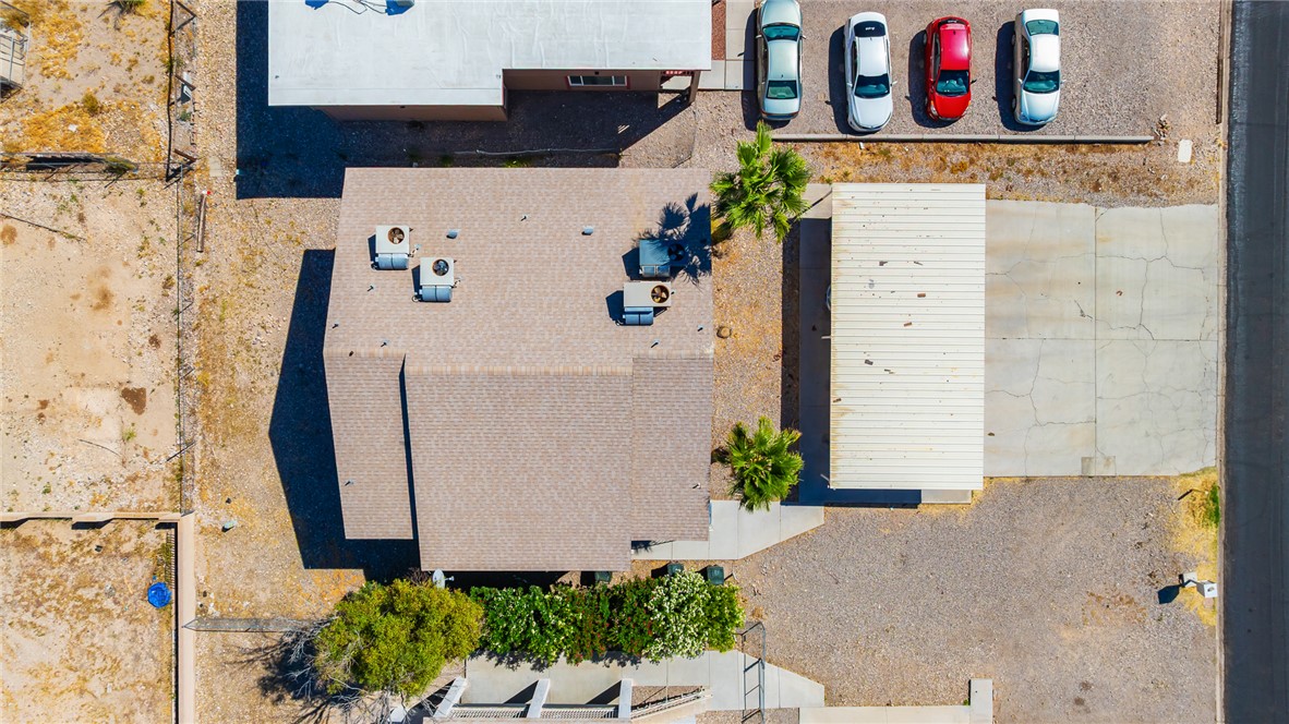 793 Baseline Road Bullhead City, AZ 86442 - Photo 45 of 49 Aerial perspective highlighting the property's roofline, multiple HVAC units, and mature landscaping