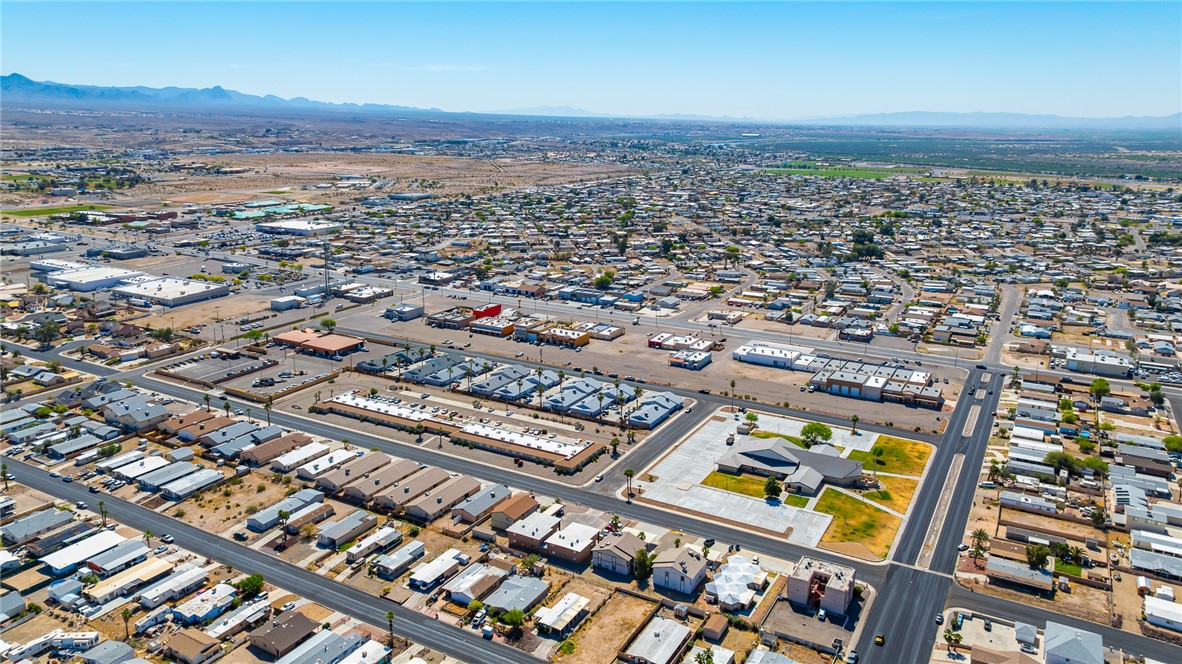 793 Baseline Road Bullhead City, AZ 86442 - Photo 47 of 49 Aerial perspective showcasing a residential community with commercial properties and distant mountain ranges
