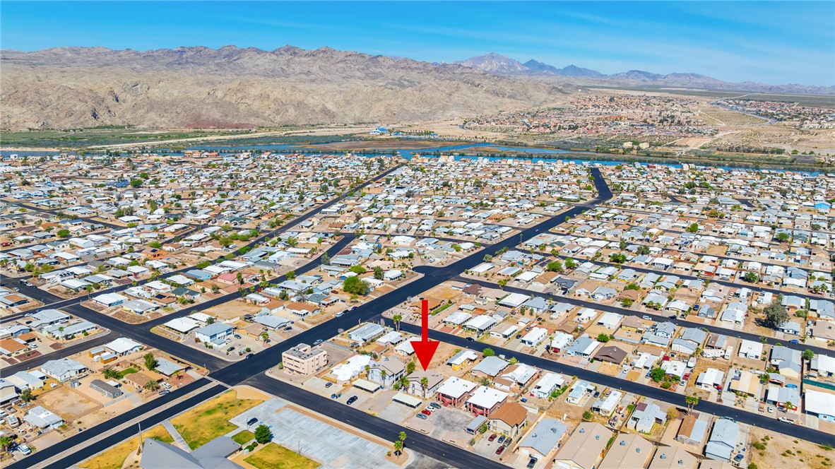 793 Baseline Road Bullhead City, AZ 86442 - Photo 48 of 49 Aerial perspective showcasing a residential community with a large body of water and distant mountains