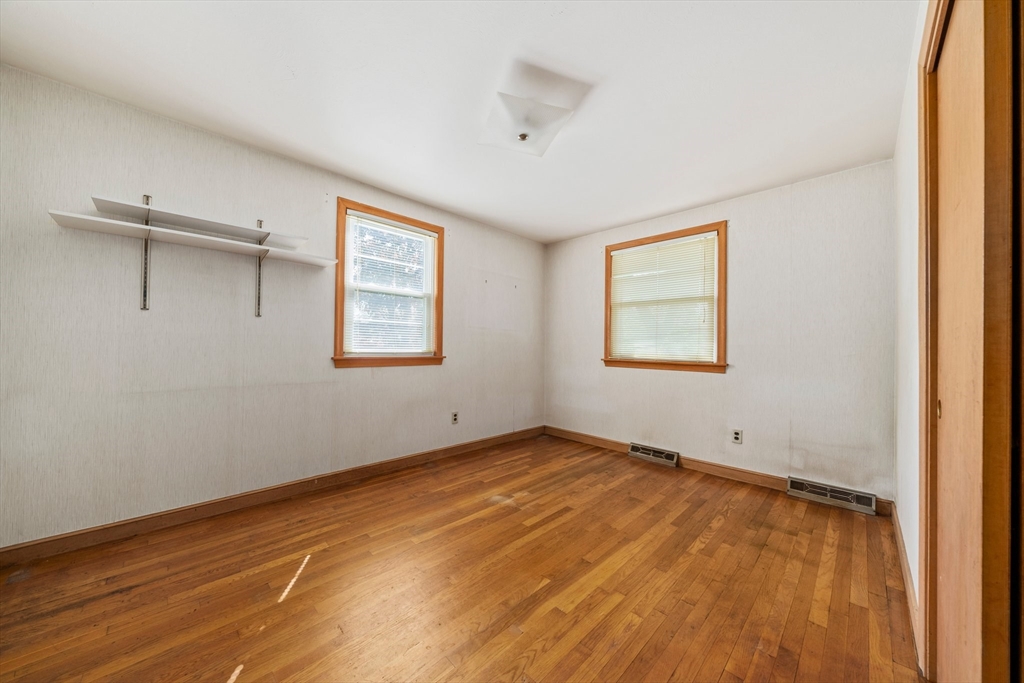 129 Devon Road Norwood, MA 02062 - Photo 16 of 32 an empty room with a window and wooden floor