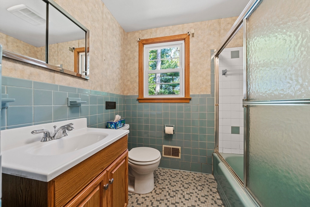 129 Devon Road Norwood, MA 02062 - Photo 18 of 32 a bathroom with a sink a toilet a shower and a mirror