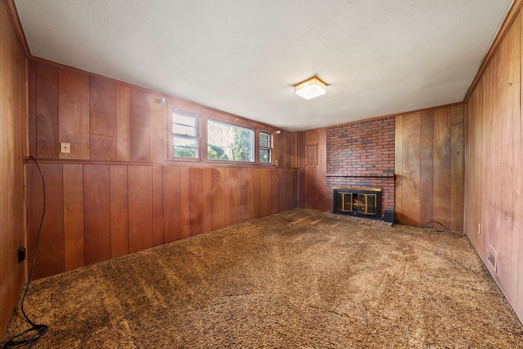 129 Devon Road Norwood, MA 02062 - Photo 19 of 32 wooden floor in an empty room with a fireplace
