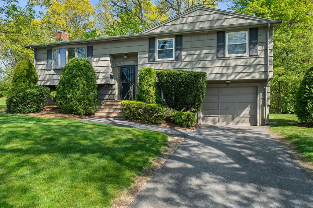 129 Devon Road Norwood, MA 02062 - Photo 2 of 32 a front view of a house with a yard and garage