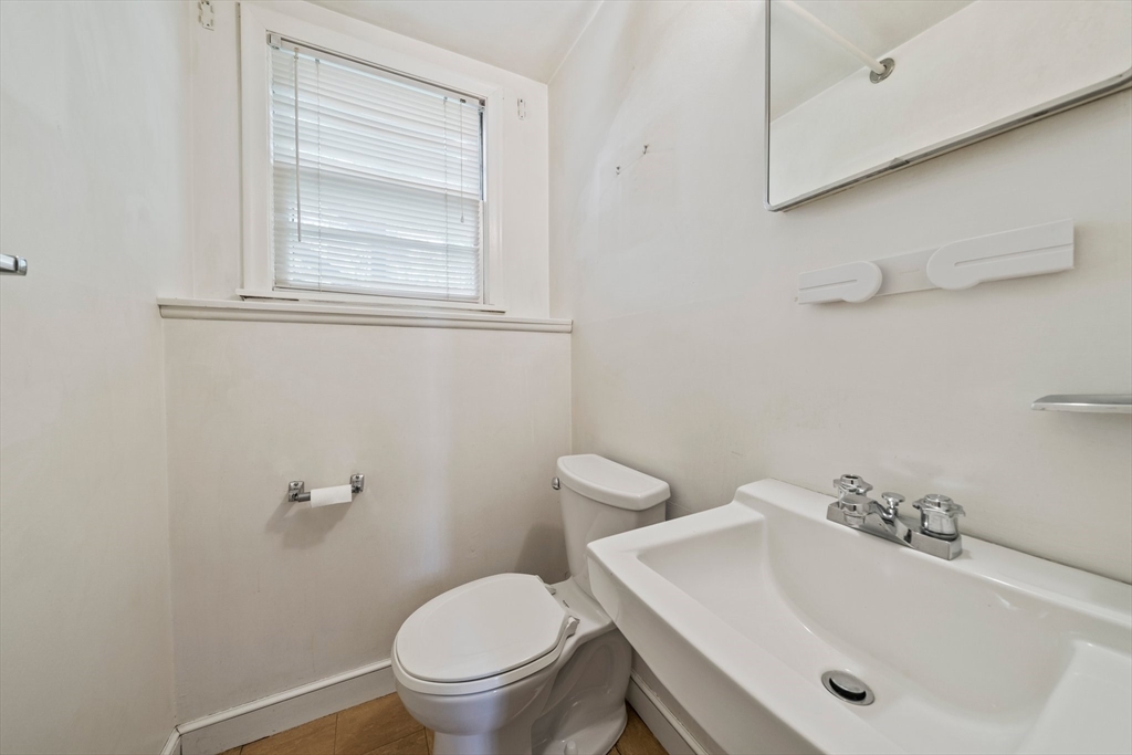 129 Devon Road Norwood, MA 02062 - Photo 23 of 32 a bathroom with a sink a toilet and a mirror