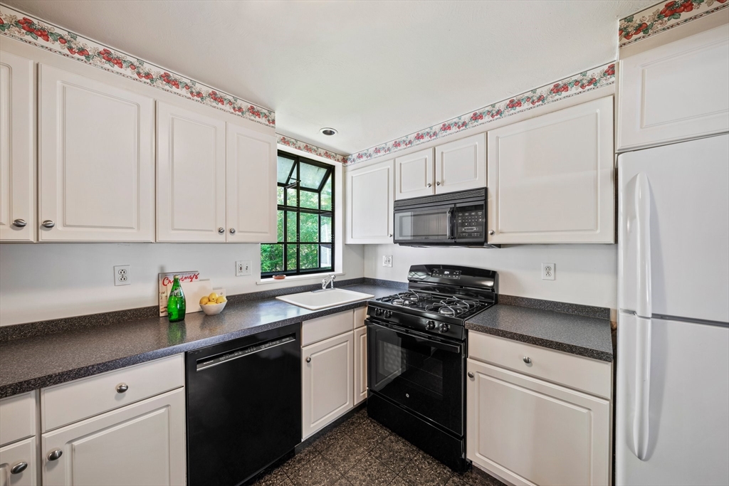 129 Devon Road Norwood, MA 02062 - Photo 5 of 32 a kitchen with appliances a sink and cabinets