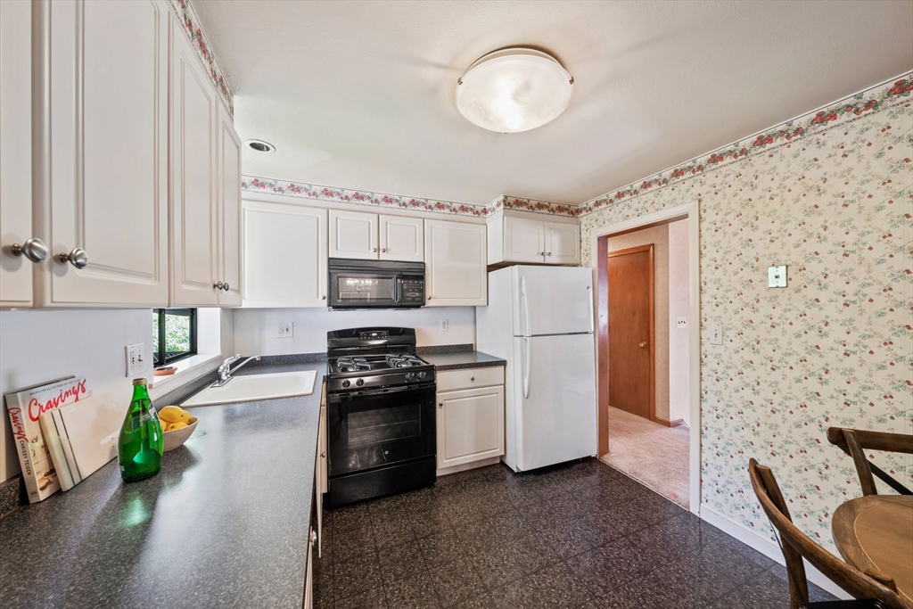 129 Devon Road Norwood, MA 02062 - Photo 7 of 32 a kitchen with stainless steel appliances granite countertop a refrigerator a stove top oven a sink and dishwasher