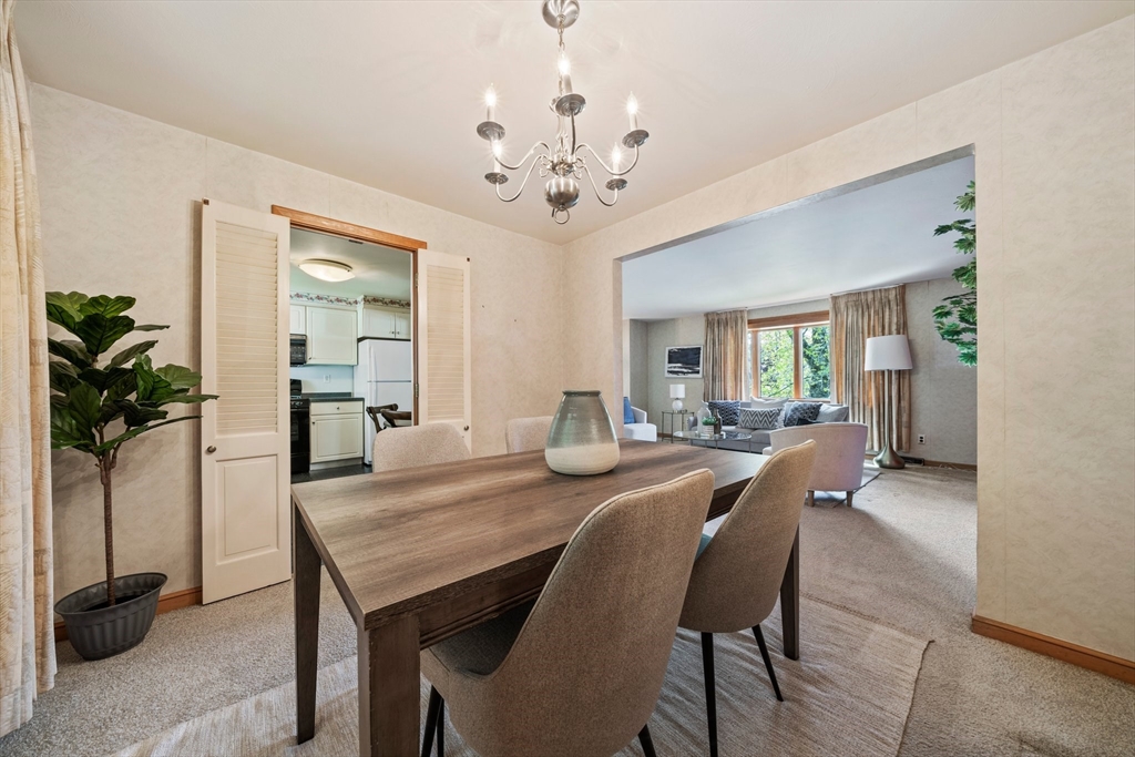 129 Devon Road Norwood, MA 02062 - Photo 10 of 32 a view of a dining room with furniture and a potted plant