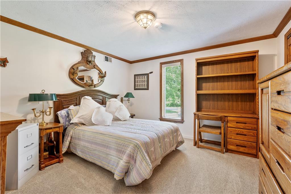 323 Wolfe Lane Irwin, PA 15642 - Photo 17 of 29 a bedroom with a bed and a chandelier