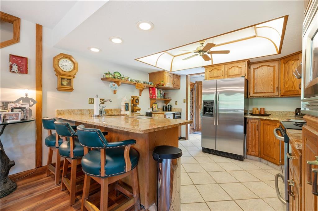 323 Wolfe Lane Irwin, PA 15642 - Photo 2 of 29 a kitchen with stainless steel appliances kitchen island granite countertop dining table chair and a refrigerator