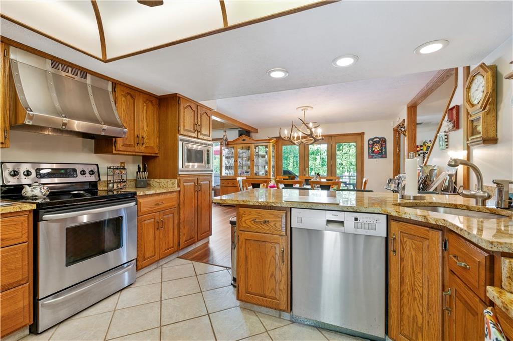 323 Wolfe Lane Irwin, PA 15642 - Photo 3 of 29 a kitchen with stainless steel appliances granite countertop a sink and cabinets